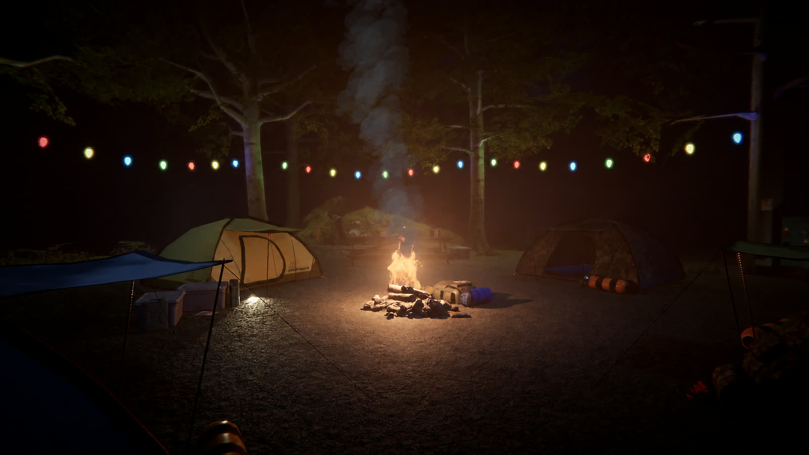 The lobby camp at night: tents, string lights and a campfire